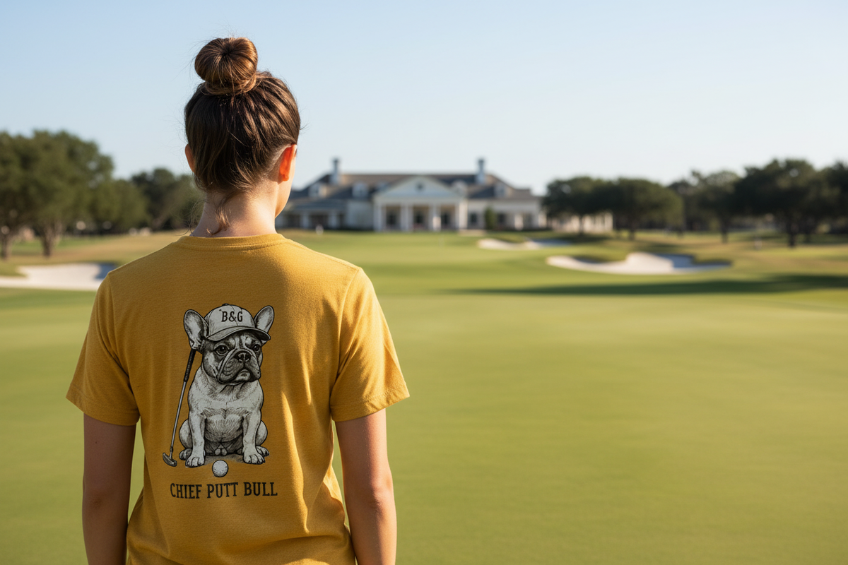 Frenchie Tri-Blend Tee female back lifestyle shot in mustard at private club putting green